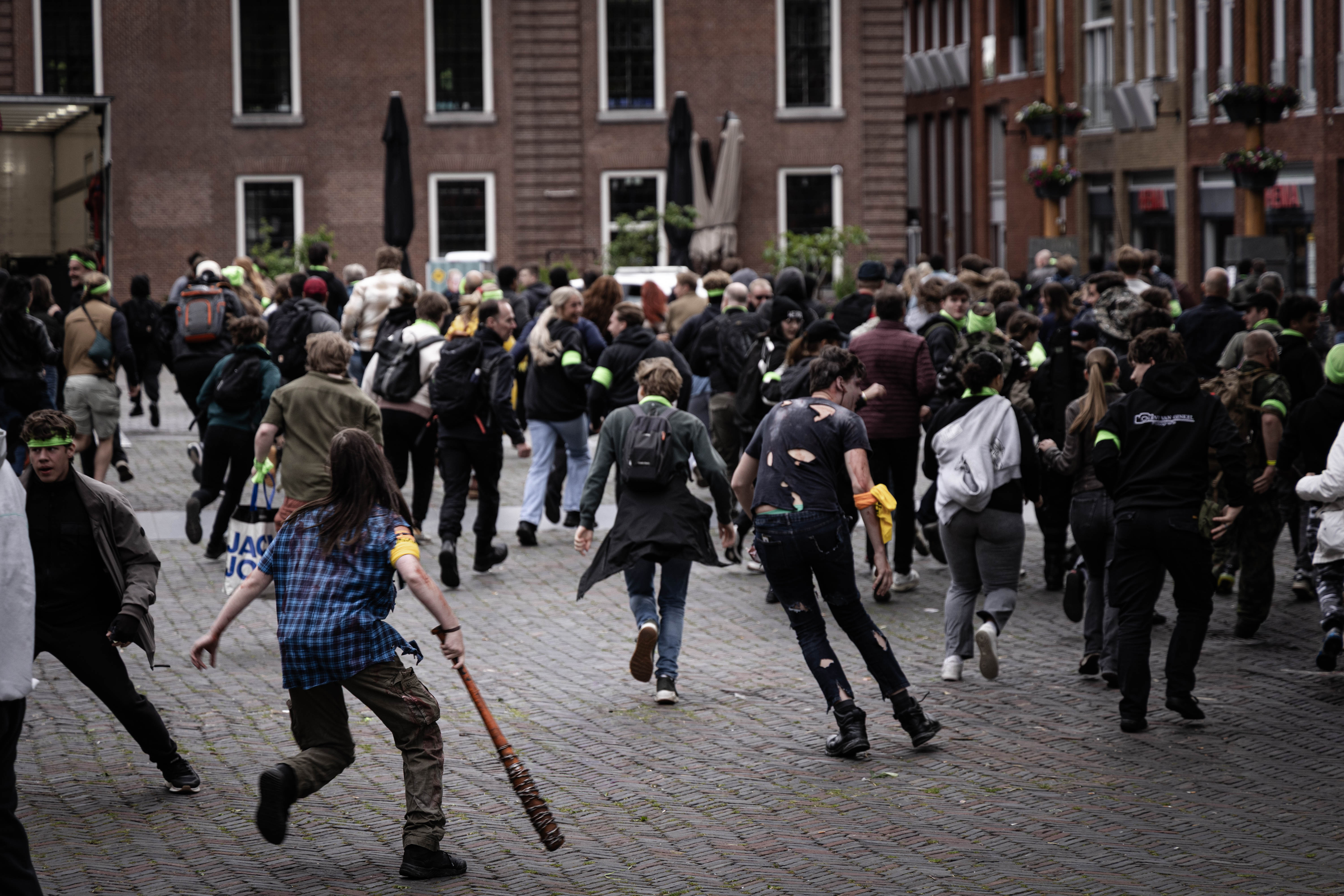 A crowd sprinting across a city square as the horde breaks out