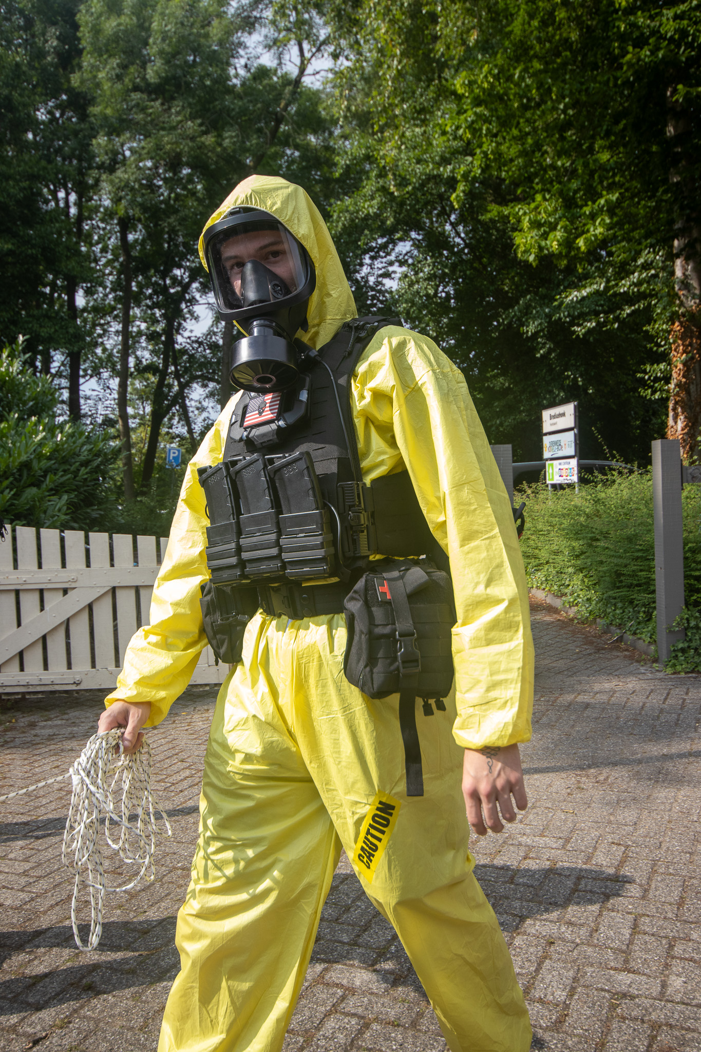 Operative in full hazmat suit with gas mask
